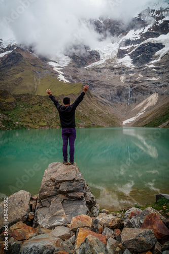 man in front of the Humantay Lake on the Salkantay Trail, the trek to Machu Picchu, Peru