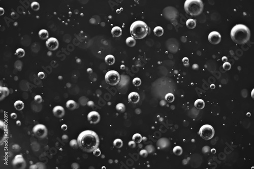 Bubbles of oxygen or air in a dark liquid. For projects with liquid or oil. Macro