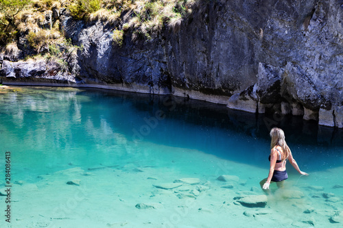 Woman enjoying the cool blue waters of the limestone caves
