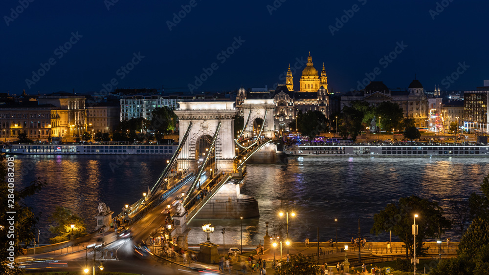 Budapest, Hungary, night view of the Basilica of St Stephen and Chain Bridge over the Danube river.