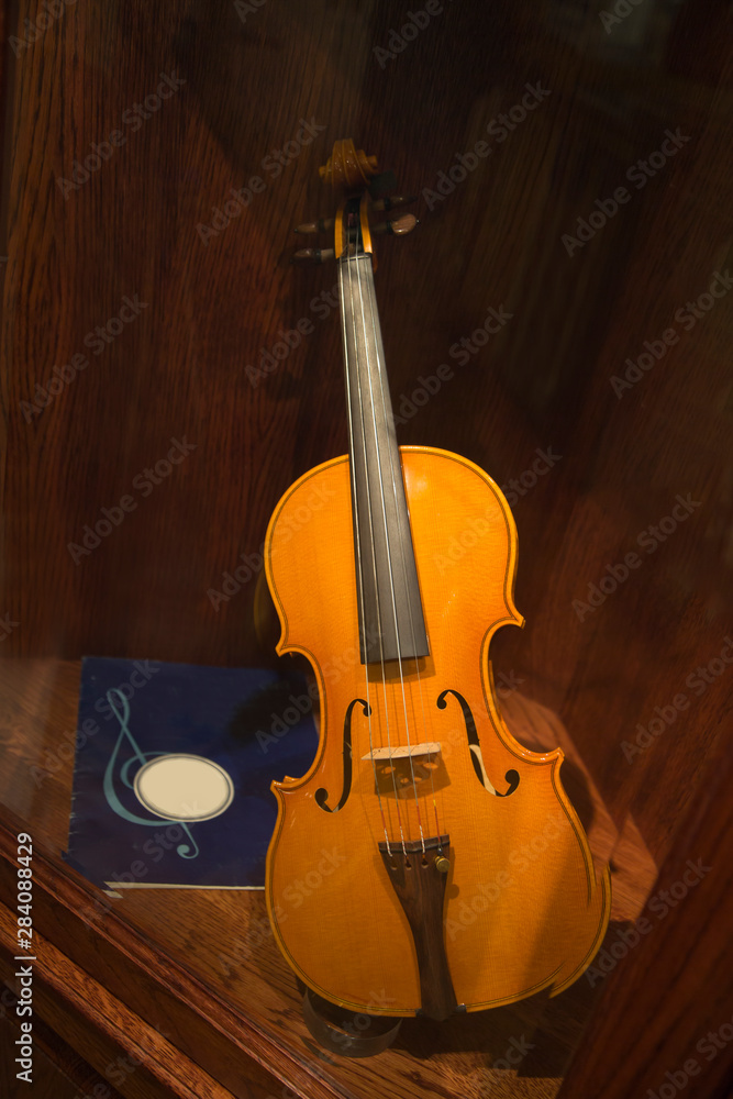 Violin ancient Notebook with notes on a mahogany background. Musical instrument. Violin ancient Notebook with notes on a mahogany background. Musical instrument.