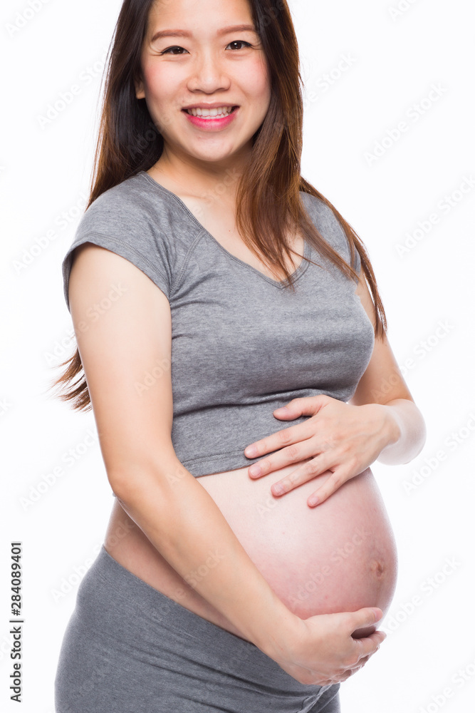 Happy asian pregnant woman smiling and touching her belly Happy asian pregnant woman smiling and touching her belly