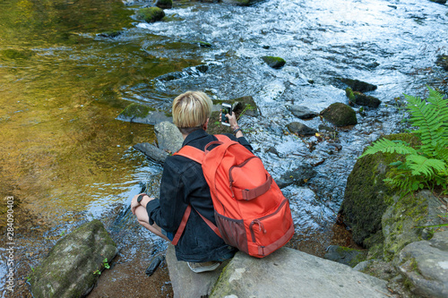 Young photographer taking photos in Tarr Steps Woodland Reserve photo