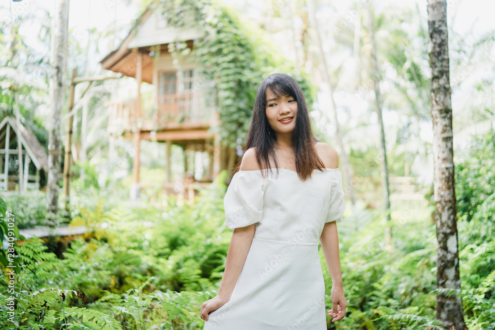 Young Asian woman relax in forest, Beautiful female happy using relax time in nature. Lifestyle women travel in forest concept. Young Asian woman relax in forest, Beautiful female happy using relax time in nature. Lifestyle women travel in forest concept.