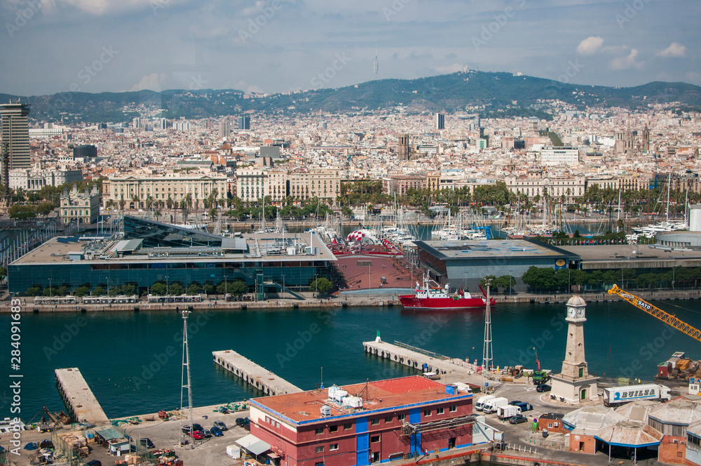 BARCELONA, SPAIN - SEPTEMBER 9, 2014: Aerial view of Barcelona, Maritime Museum, from the cableway to the Montjuic hill with the Barceloneta beach and Port Vell. Catalonia, Spain, Europe