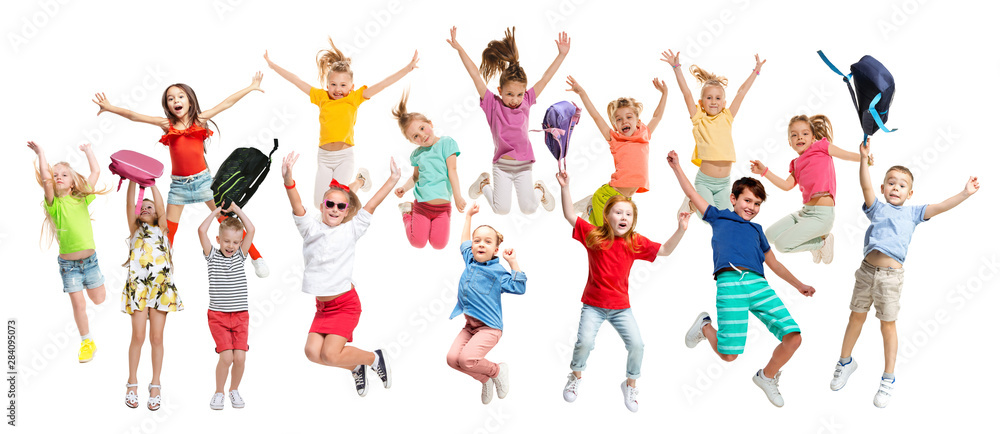 Group of elementary school kids or pupils jumping in colorful casual clothes jumping isolated on white studio background. Creative collage. Back to school, education, childhood concept. Group of elementary school kids or pupils jumping in colorful casual clothes jumping isolated on white studio background. Creative collage. Back to school, education, childhood concept.