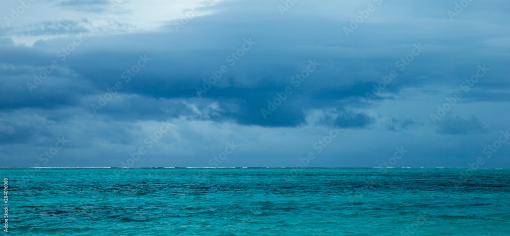 Horizontal view of dramatic overcast sky and sea.