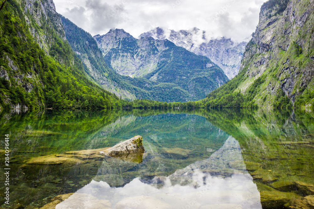 clouds over mountain lake Obersee in Germany in Alps