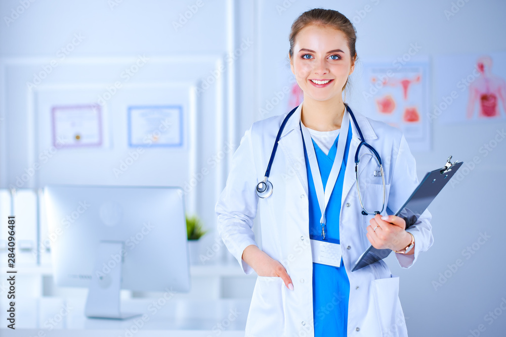 Young doctor in the office with a folder in his hands and a stethoscope. The doctor in the office. Workplace Specialist Young doctor in the office with a folder in his hands and a stethoscope. The doctor in the office. Workplace Specialist