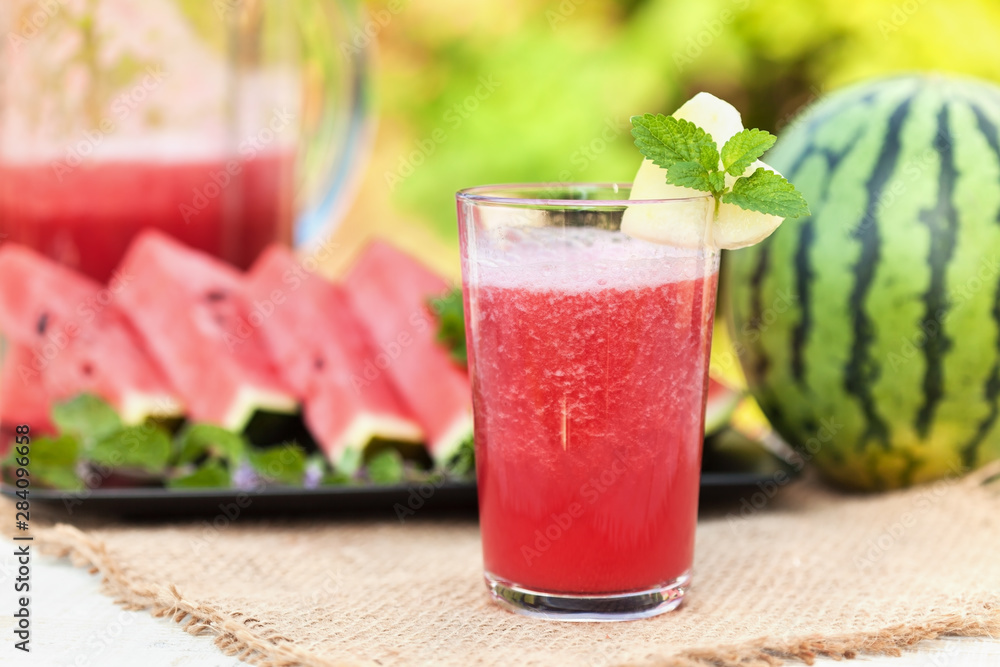 Delicious refreshing summer fruit - watermelon juice and slices on the table Delicious refreshing summer fruit - watermelon juice and slices on the table