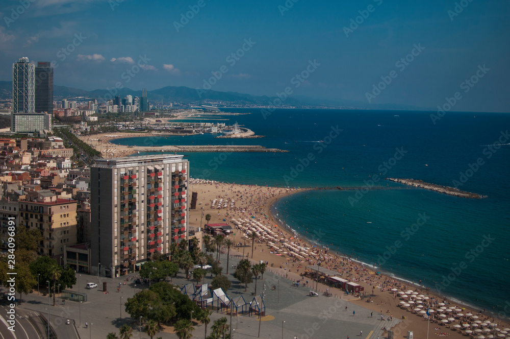 BARCELONA, SPAIN - SEPTEMBER 9, 2014: Aerial view of Barcelona from the cableway to the Montjuic hill with the Barceloneta beach and Port Vell. Catalonia, Spain, Europe