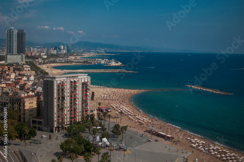 BARCELONA, SPAIN - SEPTEMBER 9, 2014: Aerial view of Barcelona from the cableway to the Montjuic hill with the Barceloneta beach and Port Vell. Catalonia, Spain, Europe © krutenyuk