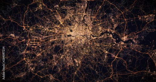 Aerial night view of city of London, UK. Traffic and street light glowing. Camera flying high above, moving closer and rotating from space filming cinematic straight down. 3d animation rendering.