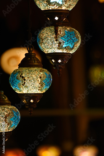 Lamps with multi-colored mosaic glasses. Night photo. Souvenirs of Turkey.