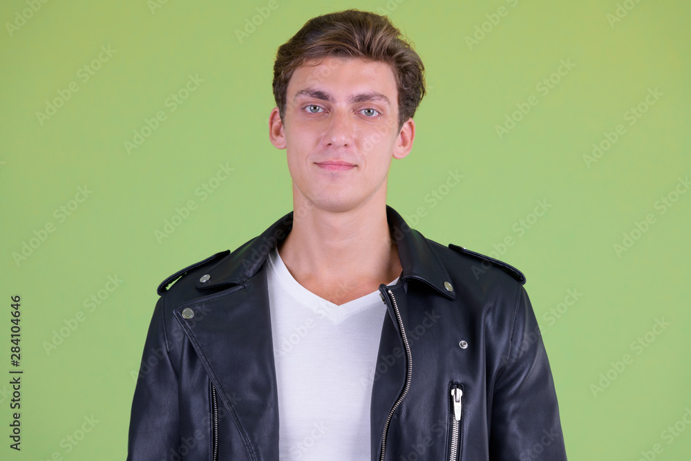 Fototapeta premium Face of young handsome rebellious man looking at camera