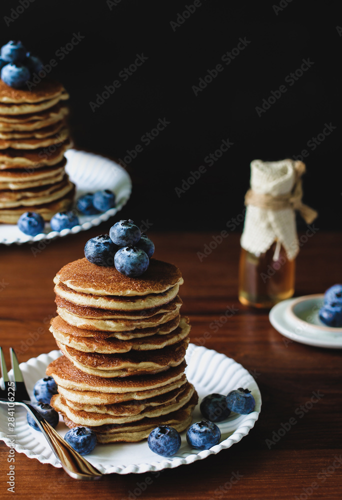 Blueberry Homemade pancake with sweet honey and fork silverware on wood table.Vertical photos