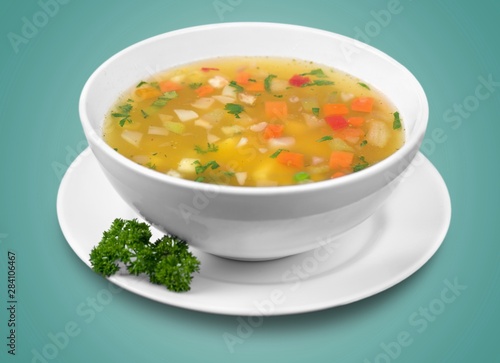 Bowl of delicious vegetables soup on table