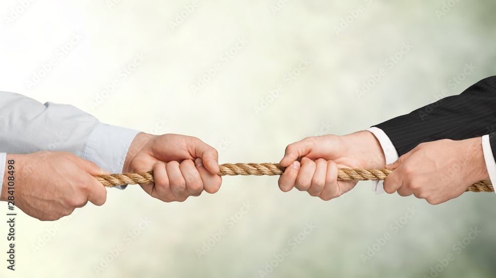 Business men hands holding rope on grey background - obrazy, fototapety, plakaty 