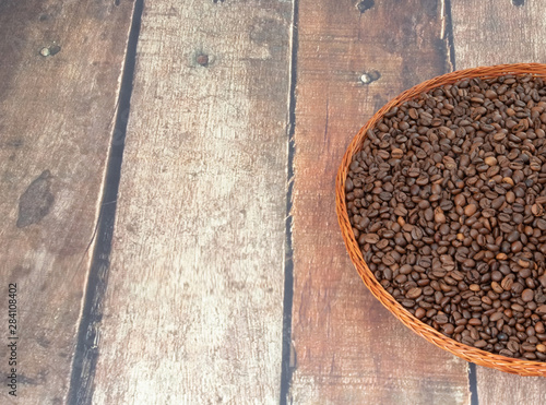 coffee grains lie in a wicker plate on a beautiful background