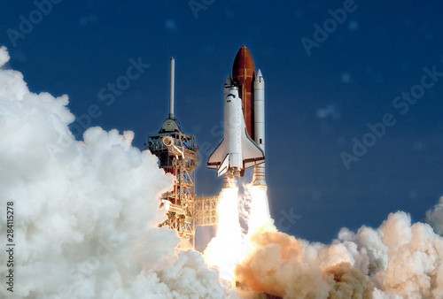 Fototapeta Naklejka Na Ścianę i Meble -  The launch of the space shuttle. With fire and smoke. Against the background of the starry sky.  Elements of this image were furnished by NASA