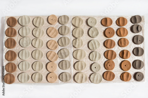 clay samplers dry. Spanish stone masses in the form of round pellets for testing glazes