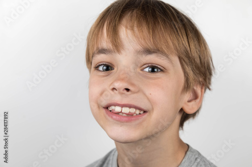 Boy's potrtait with problem teeth. A curve row and the wrong bite an occasion to visit the dentist and the orthodontist. Place for text