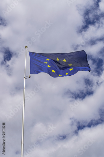 European Union flag waving, with clouds background