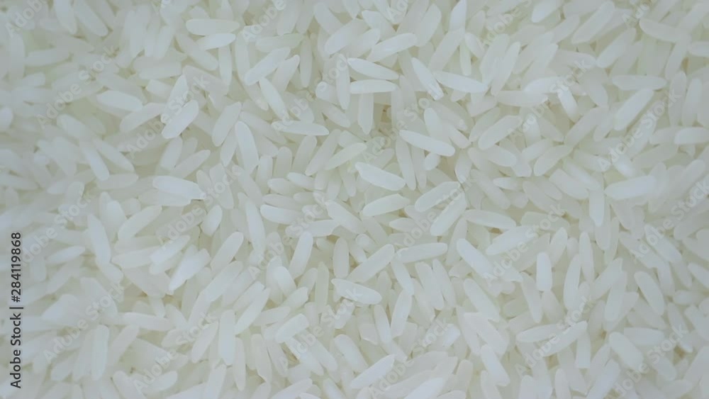 Extreme close up top view Rotation and falling down of dry raw unpolished brown rice, rice closeup,Pile of unpolished rice background