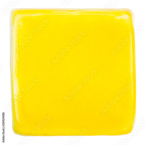 Handmade glazed yellow ceramic tile © Taigi