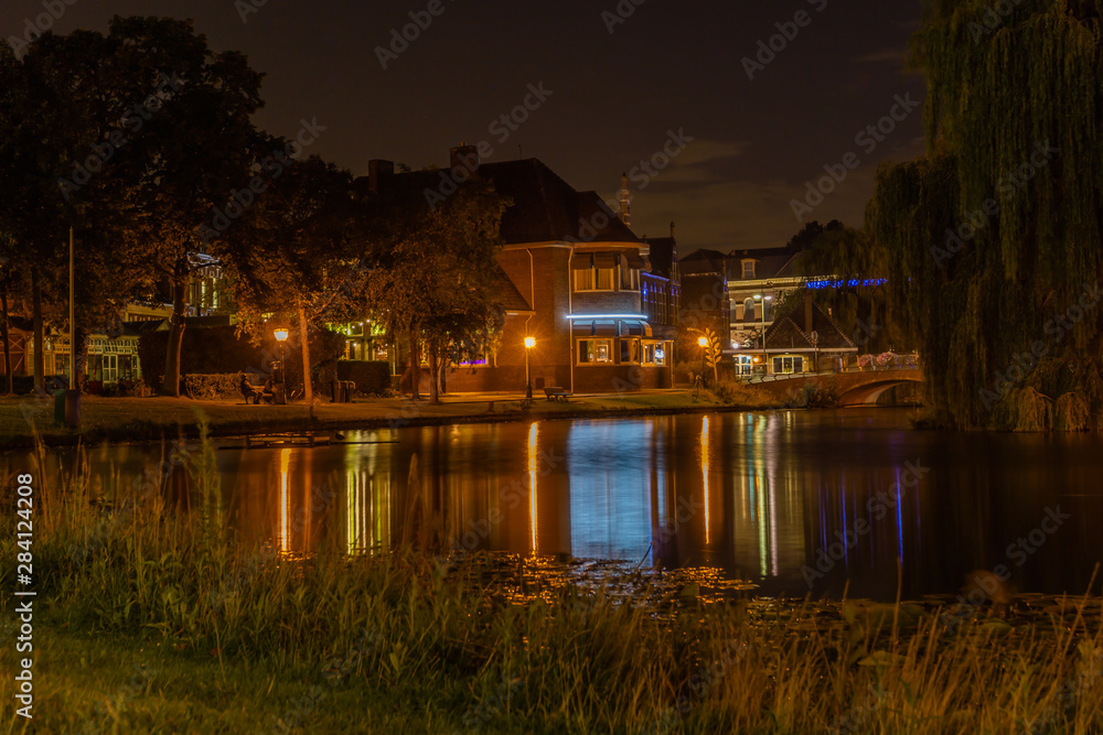 Building with blurry lights in water Building with blurry lights in water