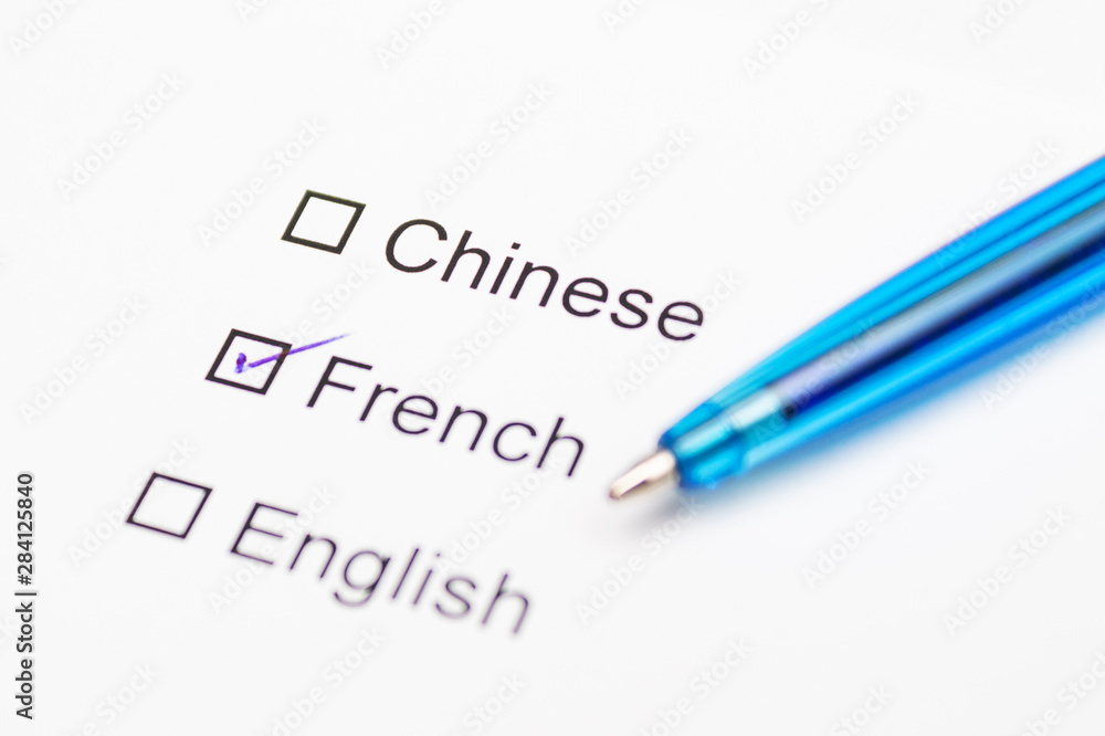 Chinese, French, English - checkmark with pen on paper. Chinese, French, English - checkmark with pen on paper.