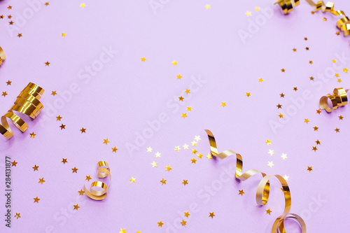 Golden decorations and sparkles on pale purple background