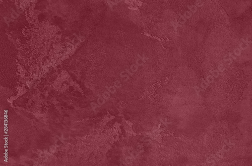 Dark red Concrete textured background to your concept or product. Winter 2020 color trend.