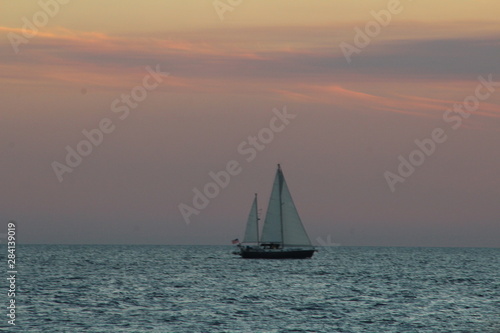 sailboat sailing after sunset