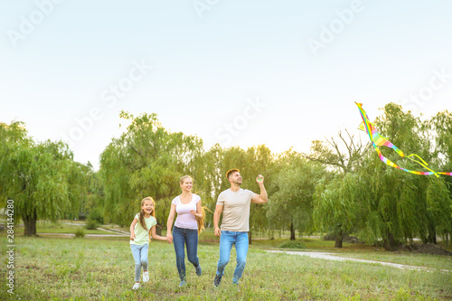 Happy family flying kite ou...