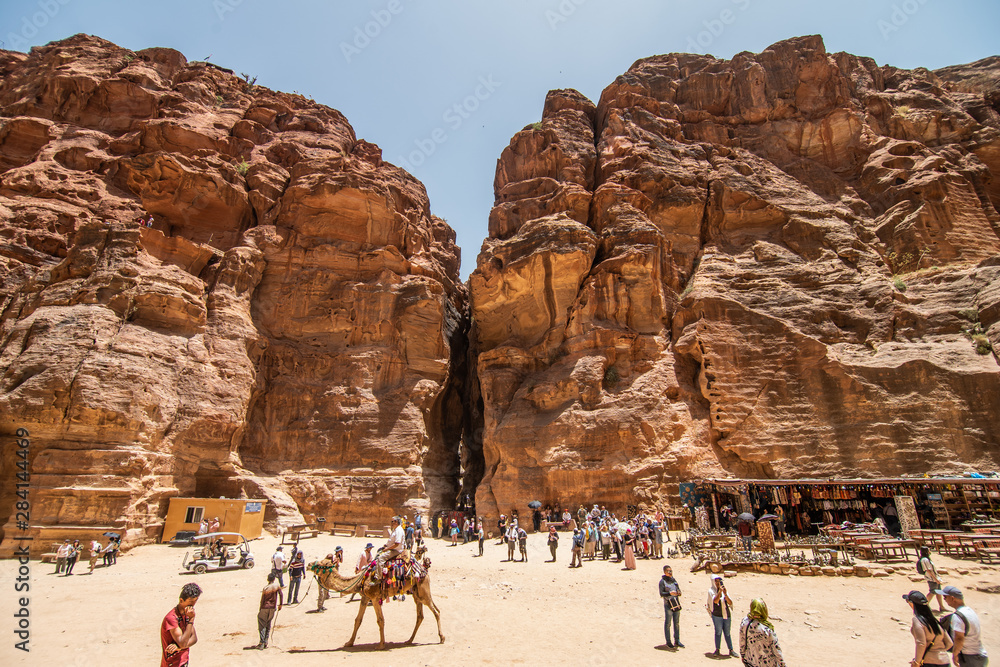 JORDAN, Petra - May 2019: Tourist complex of the ancient city of Petra with tourists and locals JORDAN, Petra - May 2019: Tourist complex of the ancient city of Petra with tourists and locals
