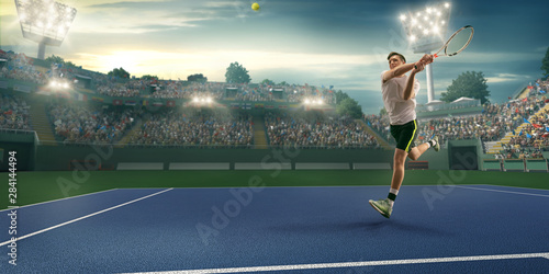 Male athlete plays tennis on a professional court © Alex