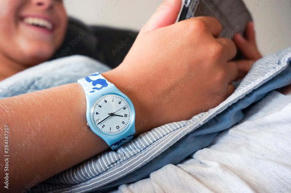 Blue Swatch watch on teenager s hand Stock Photo Adobe Stock