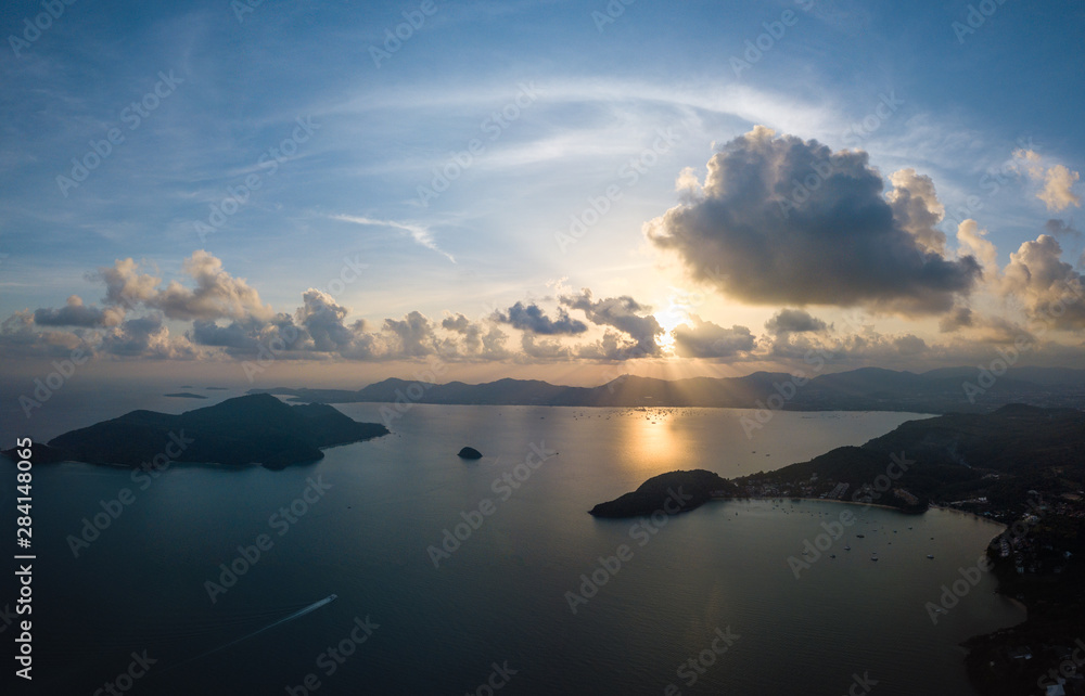 Aerial panorama view of sunset above mountain at Phuket bay with cloudy sky / landscape concept / drone photography