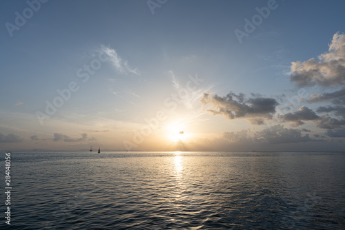 Calm sea with sunrise scene in the background / background texture / sky texture / holiday © Nut