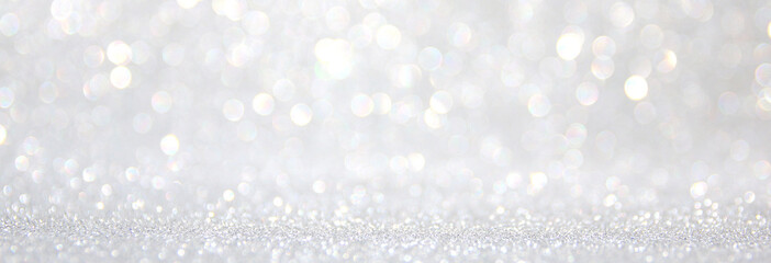 background of abstract glitter lights. silver and white. de-focused