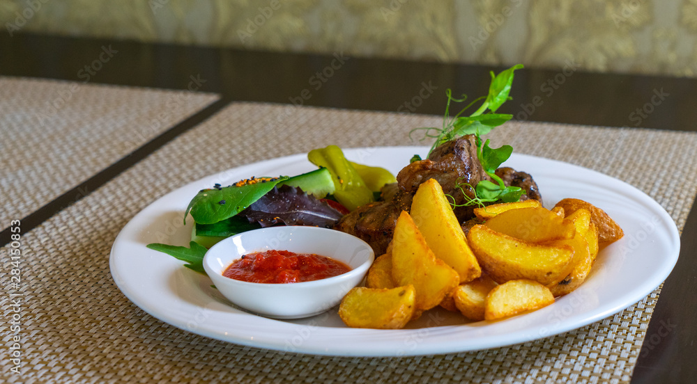 Grilled meat (kebab) with vegetables and sauce Grilled meat (kebab) with vegetables and sauce