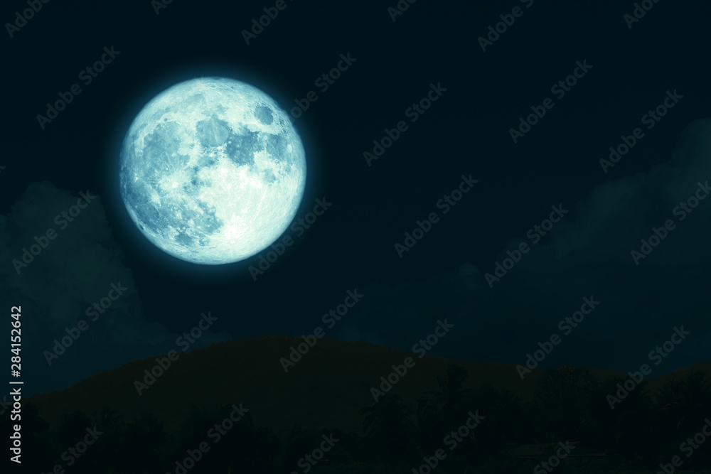 super full harvest moon on night sky back silhouette mountain