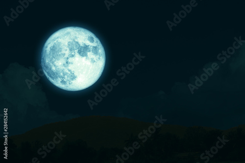 super full harvest moon on night sky back silhouette mountain