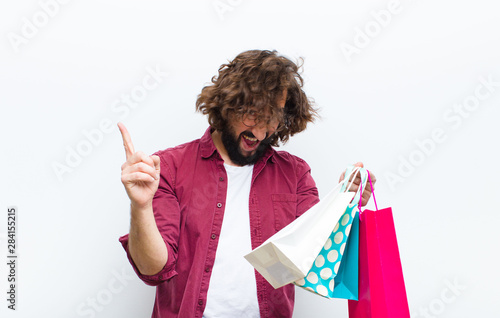 young man with crazy hair in motion shoppimg photo