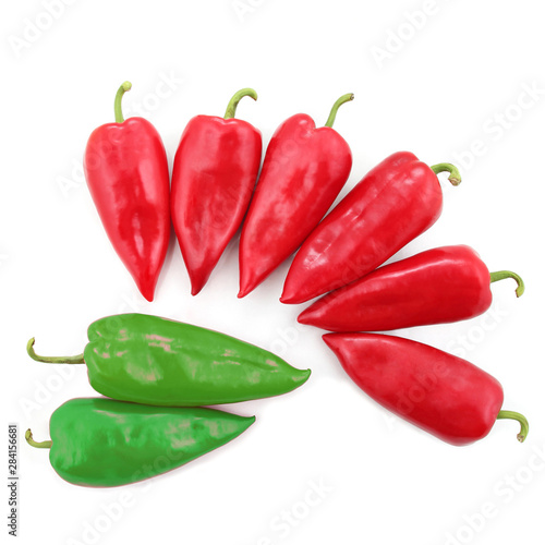 two bright green and six red sweet peppers on a white background