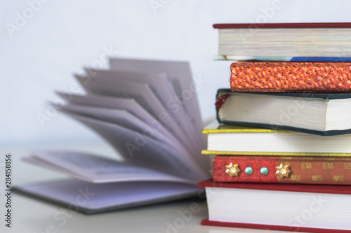 Open book on wood desk in the library room with blurred focus for background, education back to school concept, vintage color tone process