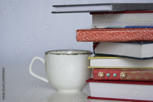 Open book on wood desk in the library room with blurred focus for background, education back to school concept, vintage color tone process