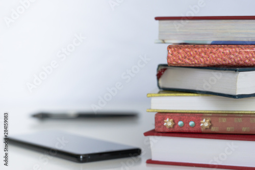 Open book on wood desk in the library room with blurred focus for background, education back to school concept, vintage color tone process