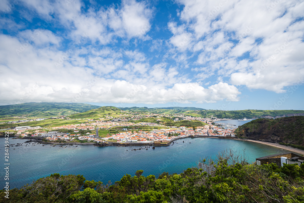 Panorama of the port of Horta and beach of Porto Pim with turquoise water and blue summer sky, Faial Island, Azores Islands, Portugal Panorama of the port of Horta and beach of Porto Pim with turquoise water and blue summer sky, Faial Island, Azores Islands, Portugal